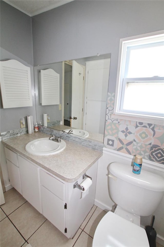 bathroom featuring vanity, tile patterned flooring, and toilet