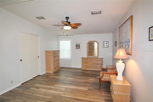 sitting room with lofted ceiling, a textured ceiling, hardwood / wood-style flooring, and ceiling fan