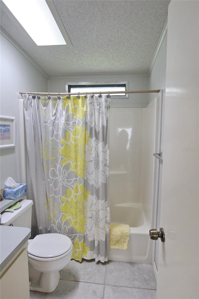 full bathroom with a textured ceiling, tile patterned floors, shower / tub combo with curtain, toilet, and vanity