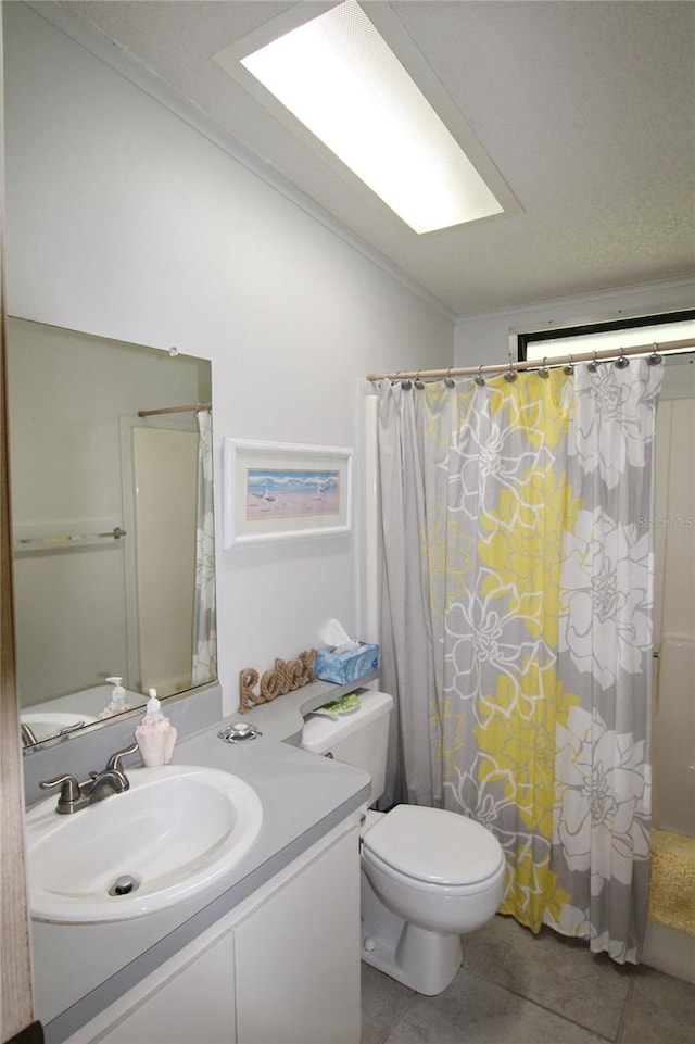 bathroom featuring tile patterned floors, toilet, and vanity