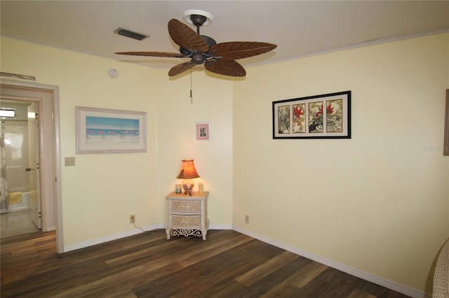 interior space featuring ceiling fan, dark hardwood / wood-style floors, and crown molding