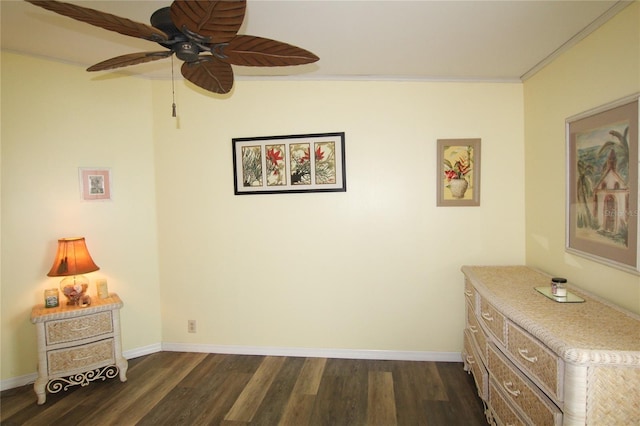 interior space with ceiling fan, crown molding, and dark wood-type flooring