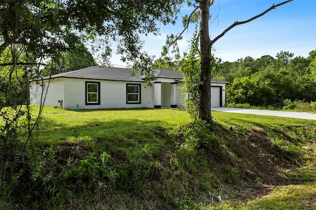 ranch-style house with a garage and a front yard