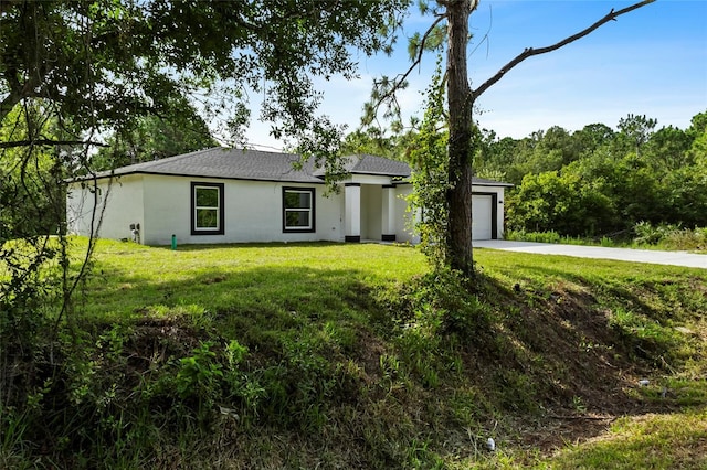 3848 NW 19th Ave, Okeechobee, FL 34972 - view of front of house featuring driveway, a front lawn, a garage, and roof with shingles