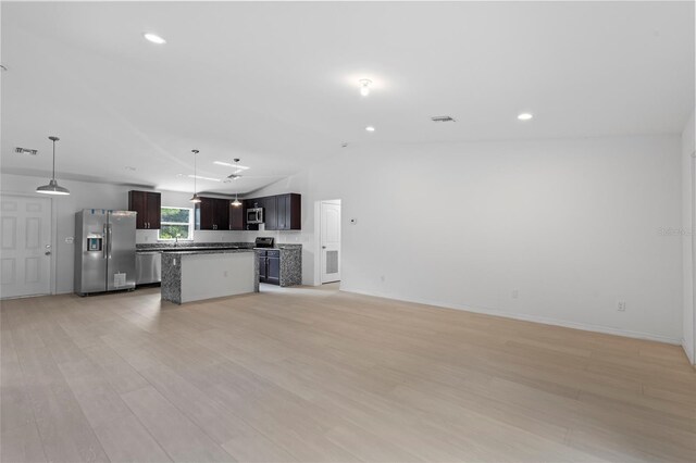 3848 NW 19th Ave, Okeechobee, FL 34972 - kitchen with visible vents, open floor plan, lofted ceiling, appliances with stainless steel finishes, and light wood-style floors