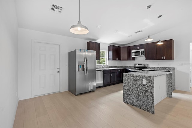 kitchen featuring decorative light fixtures, stainless steel appliances, light stone countertops, light hardwood / wood-style flooring, and lofted ceiling