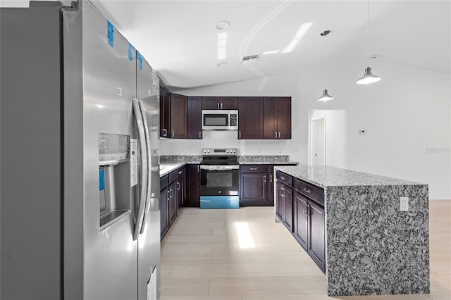 kitchen featuring lofted ceiling, dark brown cabinets, light wood-type flooring, appliances with stainless steel finishes, and decorative light fixtures