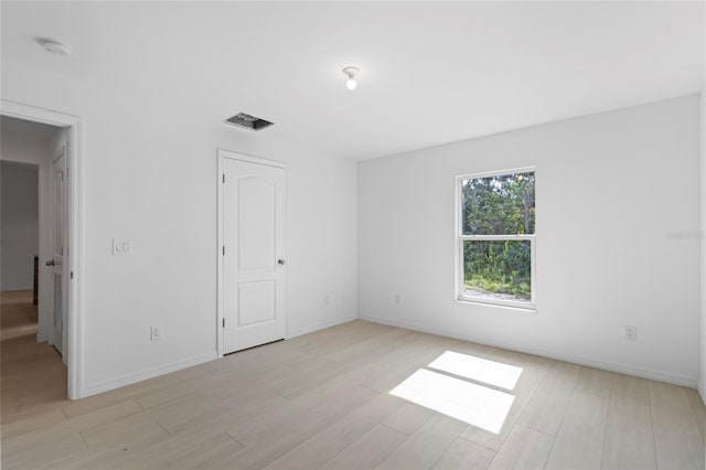 unfurnished room featuring light wood-type flooring