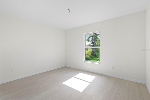 spare room featuring light wood-type flooring