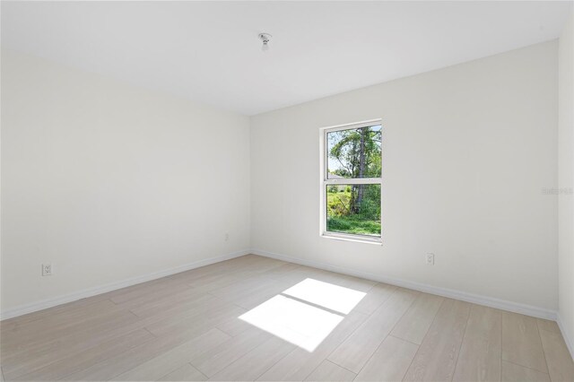 3848 NW 19th Ave, Okeechobee, FL 34972 - unfurnished room with baseboards and light wood-style floors