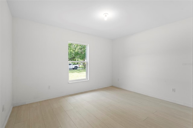 spare room with light wood-type flooring