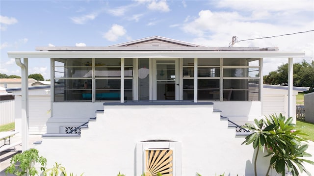 view of front of home with a sunroom