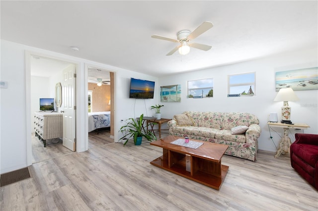 living room featuring light hardwood / wood-style flooring and ceiling fan