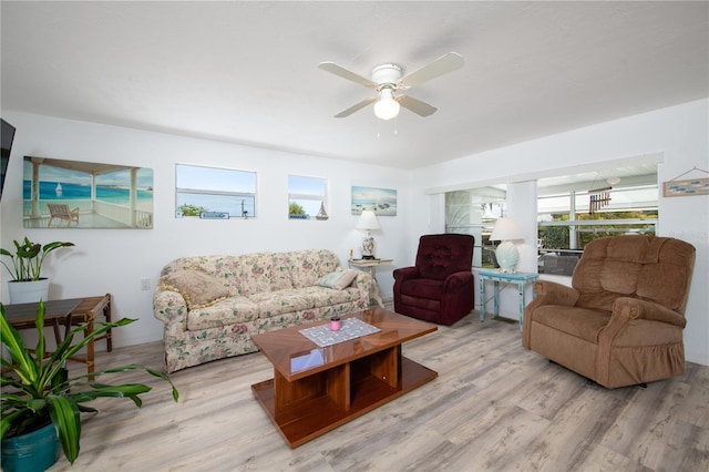 living room featuring light hardwood / wood-style floors and ceiling fan