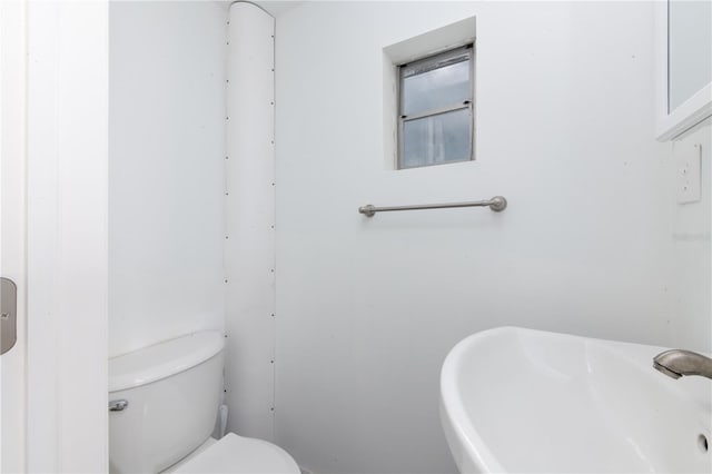 bathroom featuring toilet and sink