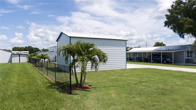 view of outbuilding featuring a lawn and a carport