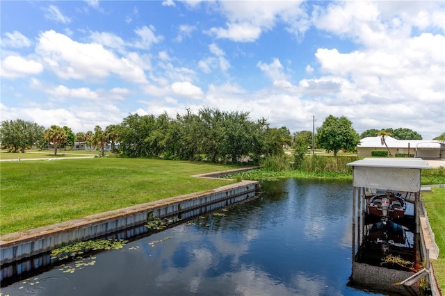 dock area with a water view and a lawn