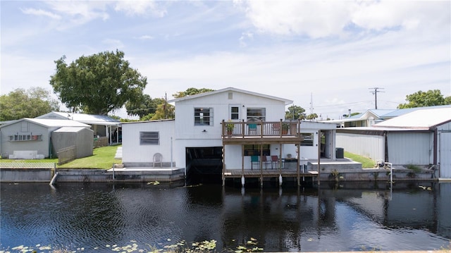 back of property with a deck with water view