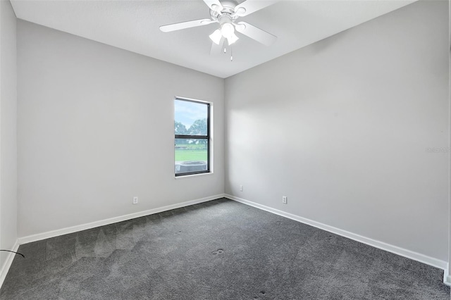 unfurnished room featuring ceiling fan and dark colored carpet