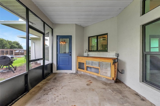 sunroom / solarium featuring plenty of natural light and sink