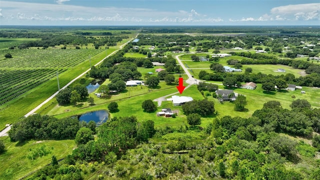 birds eye view of property with a water view and a rural view