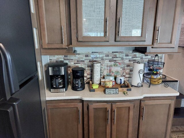 kitchen featuring decorative backsplash and stainless steel refrigerator