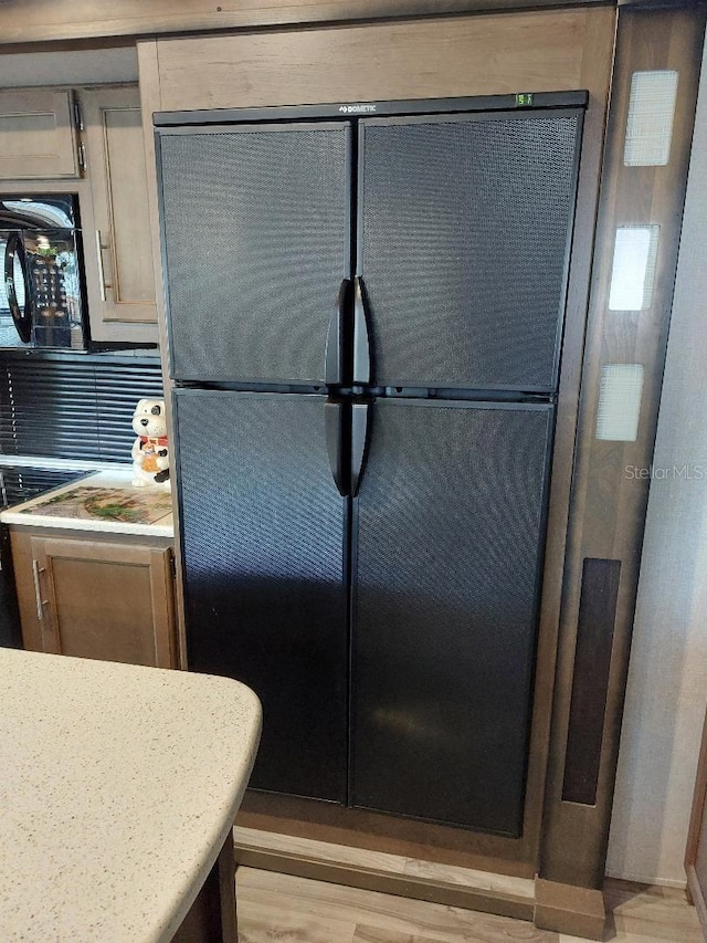 kitchen featuring black appliances and light hardwood / wood-style floors