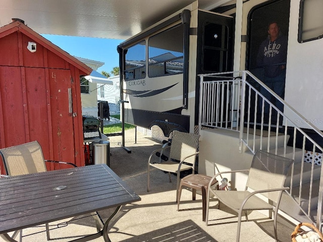 view of patio / terrace with a storage unit