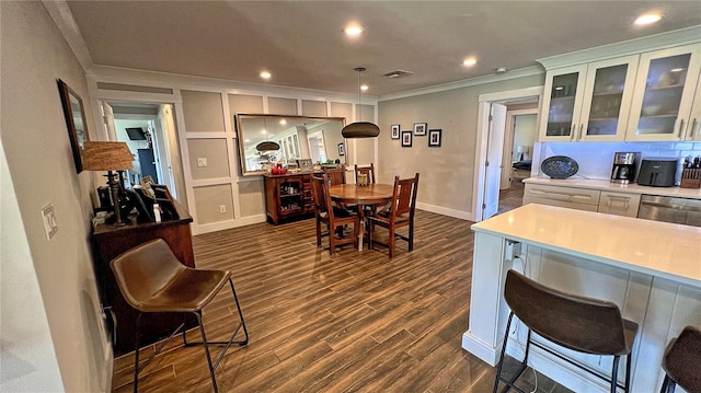 245 Lake Seminary Cir, Maitland, FL 32751 - kitchen featuring visible vents, dark wood-type flooring, a breakfast bar area, light countertops, and ornamental molding