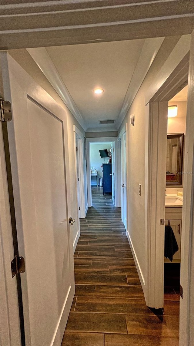245 Lake Seminary Cir, Maitland, FL 32751 - corridor with visible vents, baseboards, dark wood-type flooring, and crown molding