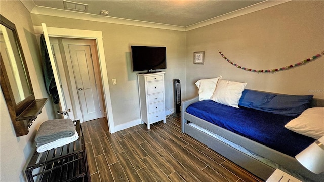 245 Lake Seminary Cir, Maitland, FL 32751 - bedroom featuring visible vents, baseboards, wood finish floors, and ornamental molding