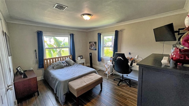 bedroom featuring ornamental molding and dark wood-type flooring