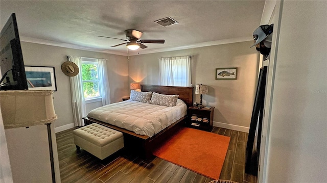 bedroom featuring crown molding, ceiling fan, and dark hardwood / wood-style floors