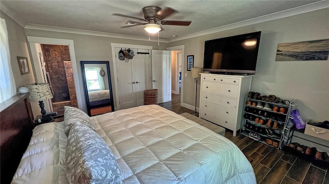 bedroom featuring a closet, ceiling fan, dark hardwood / wood-style floors, and ornamental molding