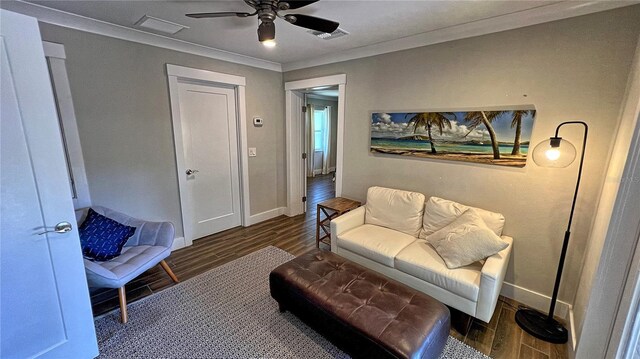 living area featuring crown molding, dark hardwood / wood-style flooring, and ceiling fan