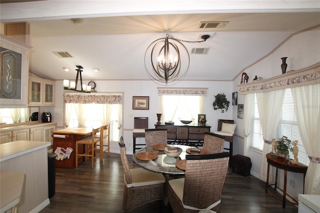 dining space featuring lofted ceiling, an inviting chandelier, a healthy amount of sunlight, and visible vents