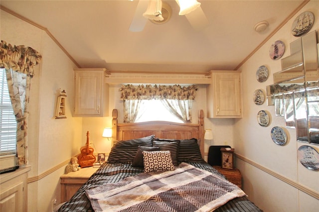 bedroom with ornamental molding, lofted ceiling, and a ceiling fan