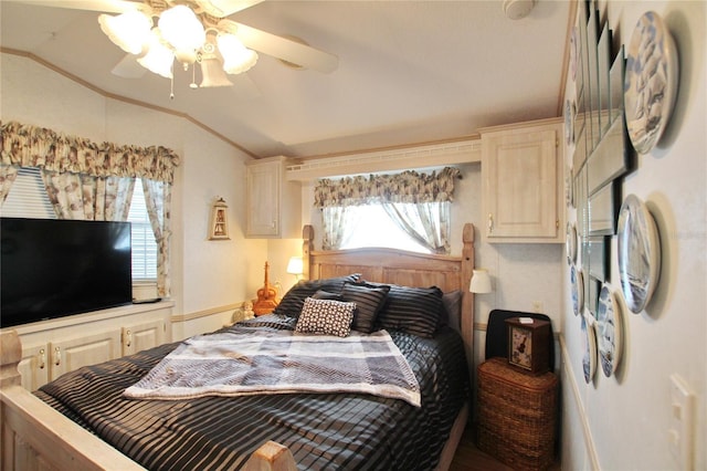 bedroom with lofted ceiling, ceiling fan, ornamental molding, and multiple windows