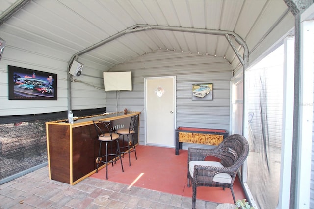 sunroom / solarium with vaulted ceiling and a bar