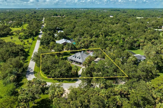 drone / aerial view featuring a view of trees