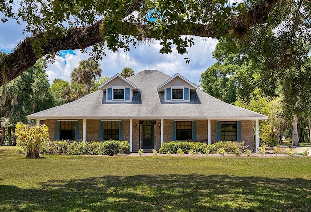 view of front of property with covered porch and a front yard