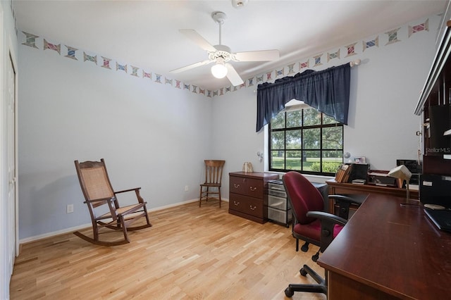 home office featuring light hardwood / wood-style flooring and ceiling fan