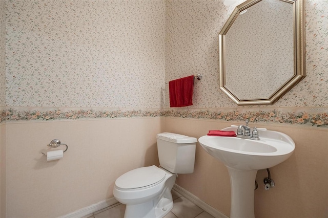 bathroom with tile patterned flooring and toilet