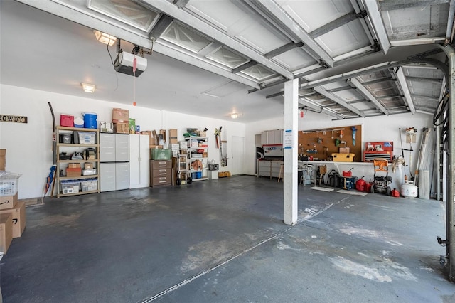 garage with a workshop area and a garage door opener