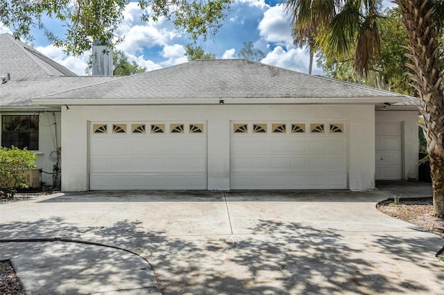 garage with cooling unit and driveway