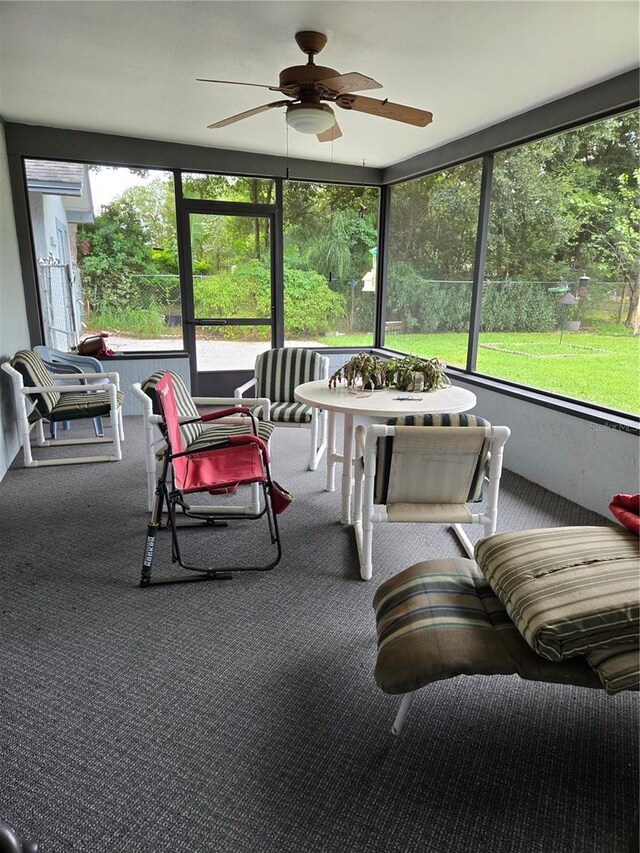 sunroom featuring ceiling fan