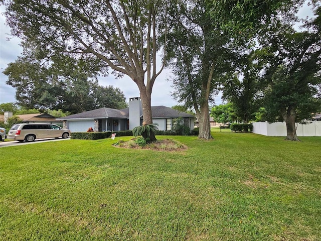 view of front of house with a garage and a front yard