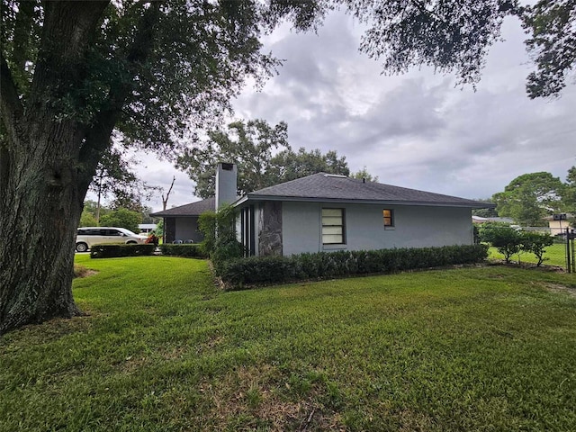 view of home's exterior with a lawn