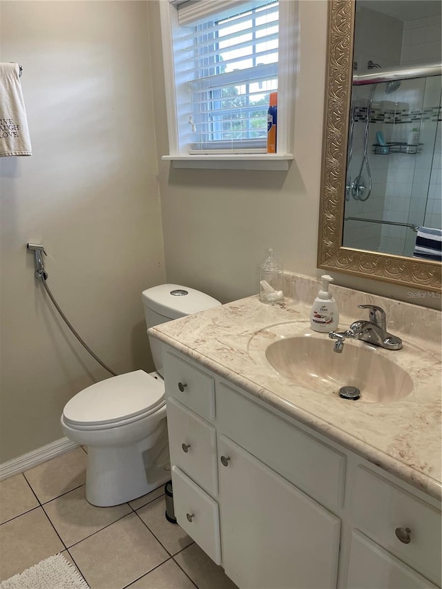 bathroom with vanity, toilet, a shower with door, and tile patterned floors