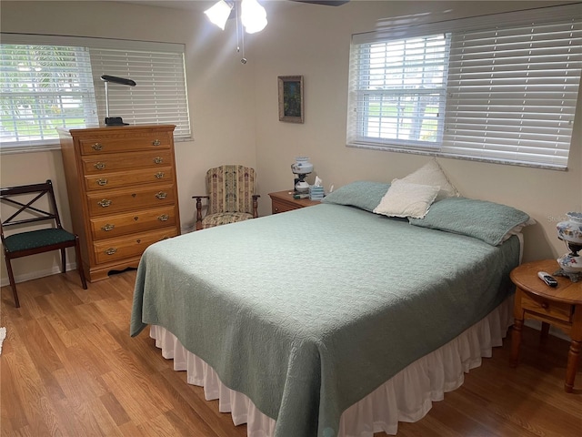 bedroom with wood-type flooring and ceiling fan